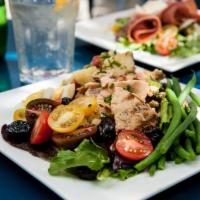 Salmon Nicoise Salad · Grilled salmon, herbed new potatoes, green beans, tomato, olives and hard-boiled egg on mixe...