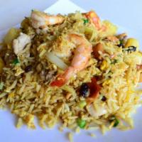 76. Pineapple Fried Rice · Fried rice with chicken and shrimp, pineapple, raisin, cashew nuts, tomatoes, egg, onion, gr...
