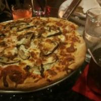Portobello Mushroom Pizza · Portobello mushroom, tomato sauce, caramelized onion, mozzarella cheese, and truffle oil.