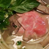 28. Rare Steak and Well Done Brisket Noodle · Special beef or chicken soup cooked from bone with rice noodle, cilantro, onion and your cho...