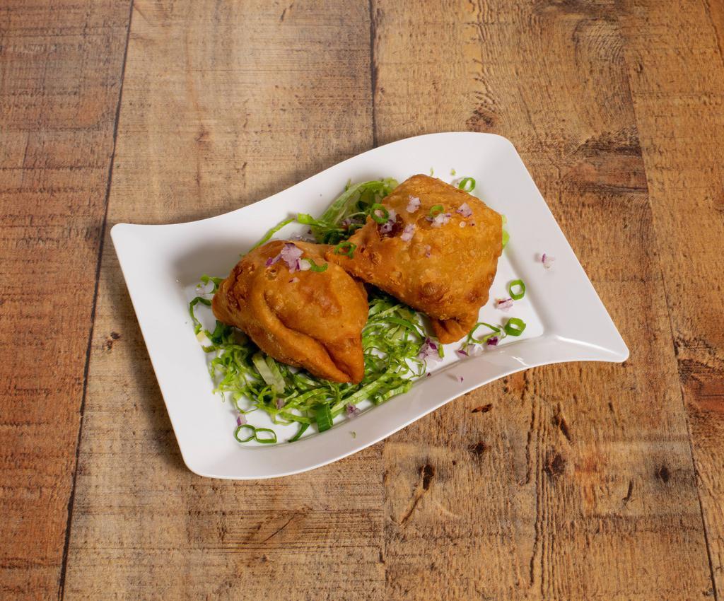 Samosa · Triangular pies stuffed with potatoes and peas with spices and herbs. 