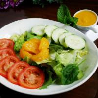 Garden Salad · Fresh mixed greens, tomato and cucumber with sesame ginger dressing.