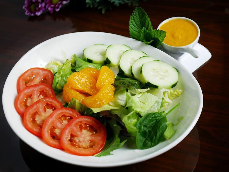 Garden Salad · Fresh mixed greens, tomato and cucumber with sesame ginger dressing.