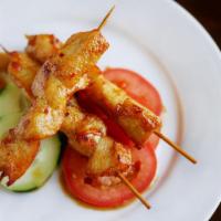 Chicken Satay · Chicken skewers marinated in Thai spices and grilled to perfection, served with spicy peanut...