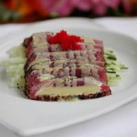 Tuna Cappaccio · Sliced black pepper tuna with homemade honey wasabi sauce.