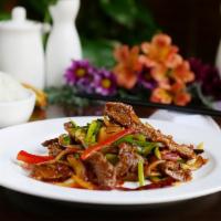 Sichuan Beef · Flank steak stir-fried with bell pepper and onion in a spicy Sichuan peppercorn sauce.