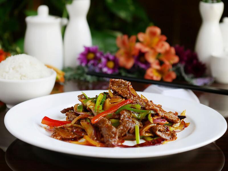 Sichuan Beef · Flank steak stir-fried with bell pepper and onion in a spicy Sichuan peppercorn sauce.