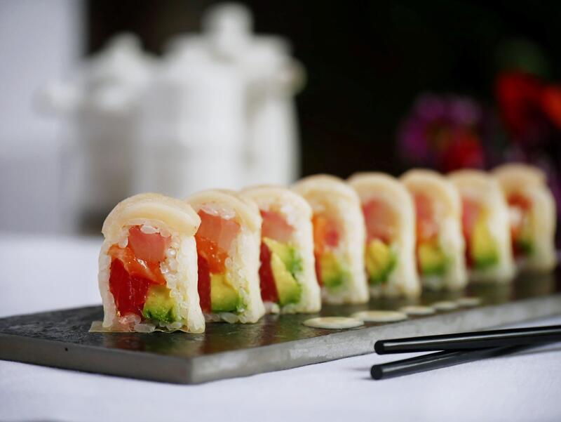 Snow White Roll · Tuna, salmon, yellowtail and avocado rolled in white soy paper, topped with white tuna and yum yum sauce.