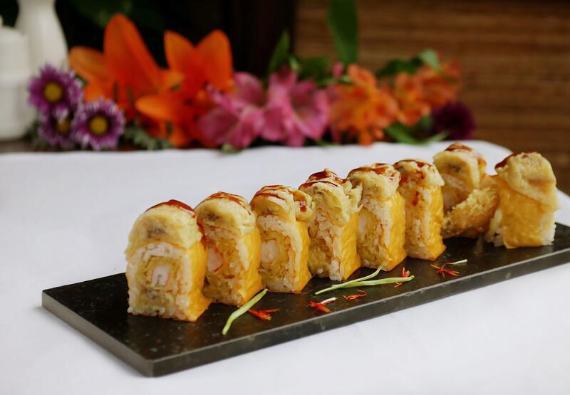 Banana Roll · Tempura shrimp and banana wrapped in soy paper, topped with tempura banana and eel sauce.