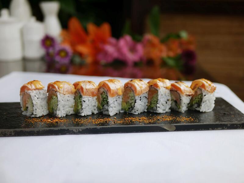 Smoky Salmon Roll · Smoked salmon, cream cheese and cucumber, topped with lightly torched salmon and schichimi togarashi (Japanese seven spice blend).