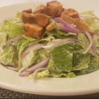 Caesar Salad · Romaine, Red Onion, Homemade Croutons, and Caesar Dressing.