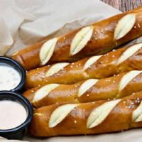 House Baked Soft Pretzels · Salted pretzels with white queso, yellow mustard & sriracha ranch.
