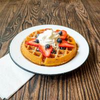 Belgian Waffle · Maple syrup and whipped butter. Fresh berries, banana, chocolate chip or whipped cream for a...