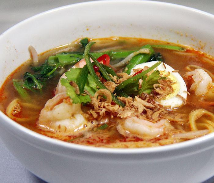 Hokkien Prawn Mee Noodle Soup · Malaysian kang kung, bean sprouts, hard-boiled egg, fried shallots and garlic in spicy shrimp broth with rice noodle.