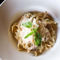 Fettuccine Alfredo with Chicken · Parmesan cream sauce tossed with fettuccine and rotisserie chicken.
