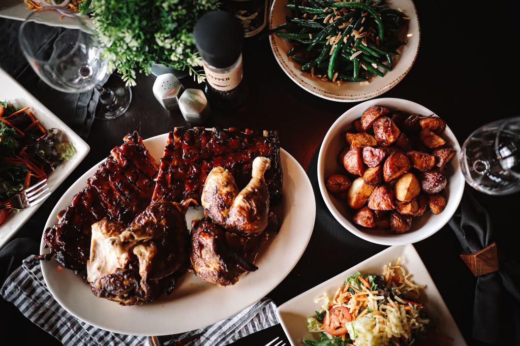 Rib and Chicken Combo Family · Two 1/2 racks with BBQ, 1 whole signature rotisserie chicken, house salad with choice of dressing served on the side, green beans, roasted baby red potatoes, and carrot cake for sharing.