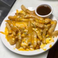Cheese Fries · House fries topped with cheddar Jack cheese and served with gravy for dipping delight Add ba...