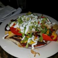 LZ Nachos · Your choice of chicken or steak, pinto beans, lettuce, sour cream, queso dip, tomato and jal...