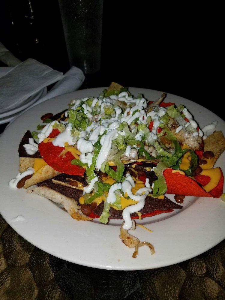 LZ Nachos · Your choice of chicken or steak, pinto beans, lettuce, sour cream, queso dip, tomato and jalapeno over a bed of chips.