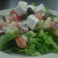 Greek Salad · Tomato, cucumbers, green peppers and onions tossed in vinaigrette, topped with feta cheese a...