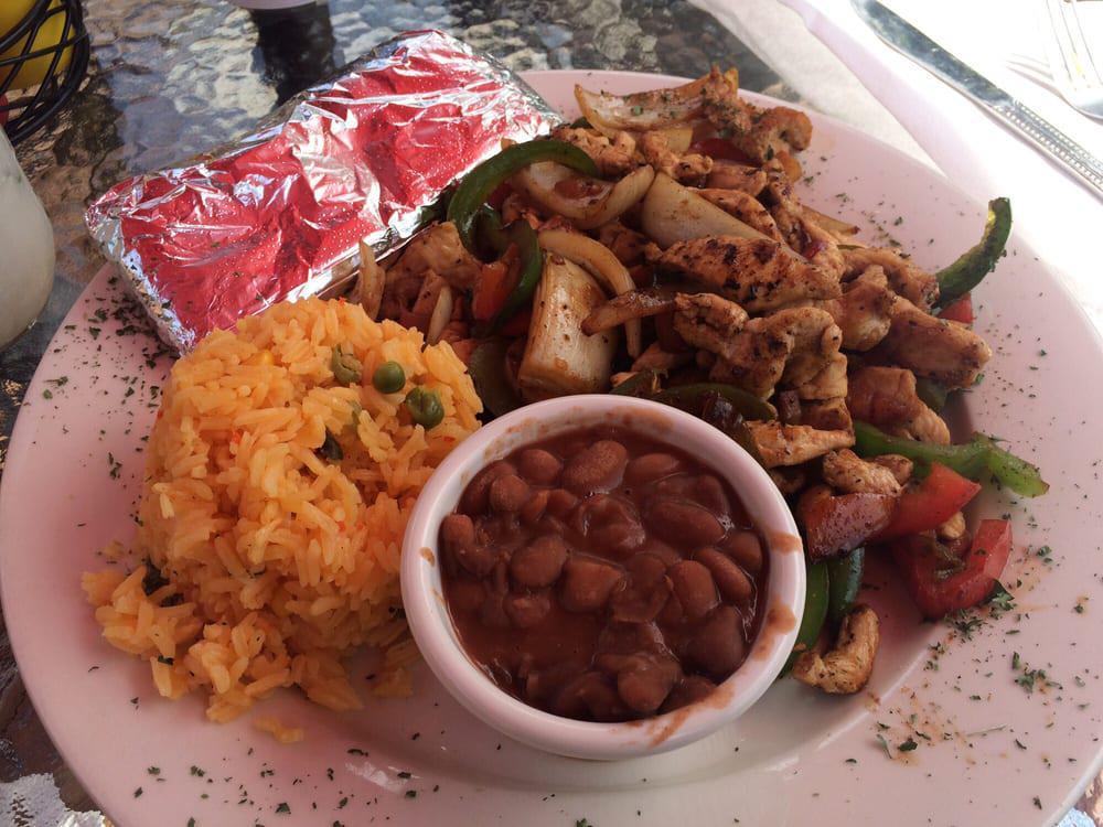 Fajitas · Served with grilled peppers, onions, rice, tomatoes, beans, pico de gallo with flour or corn (gluten free) tortillas. Gluten free.
