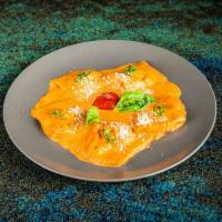 Agnolotti di Pollo · Ravioli like pasta with chicken, ricotta cheese, and pink sauce.