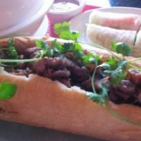 BBQ Pork Baguette · Our BBQ pork banh mi comes with our special butter, daikon (pickled carrots and radishes), c...