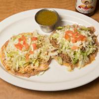 Tostadas de Deshebrada · 3 deep fried corn tortillas with spread refried beans, topped with shredded beef or chicken,...