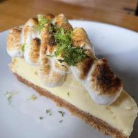 Key Lime Pie · House made key lime pie and graham cracker crust topped with a toasted meringue.