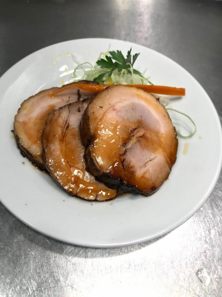 Chashu (Pork Belly) Kozara · Sliced simmered Pork Belly chunks. Topped with house special sauce, and touch of spicy sesame oil. (2 -3 slices depending on size and thickness)