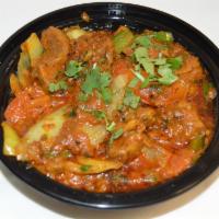 32. Lamb Karahi · Cubes of lamb cooked with green peppers, onions, tomatoes, ginger, garlic and herbs. Served ...