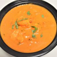49. Shrimp Tikka Masala · Shrimp, onion, bell pepper and garlic, cooked with tomato sauce and cream. Served with rice.