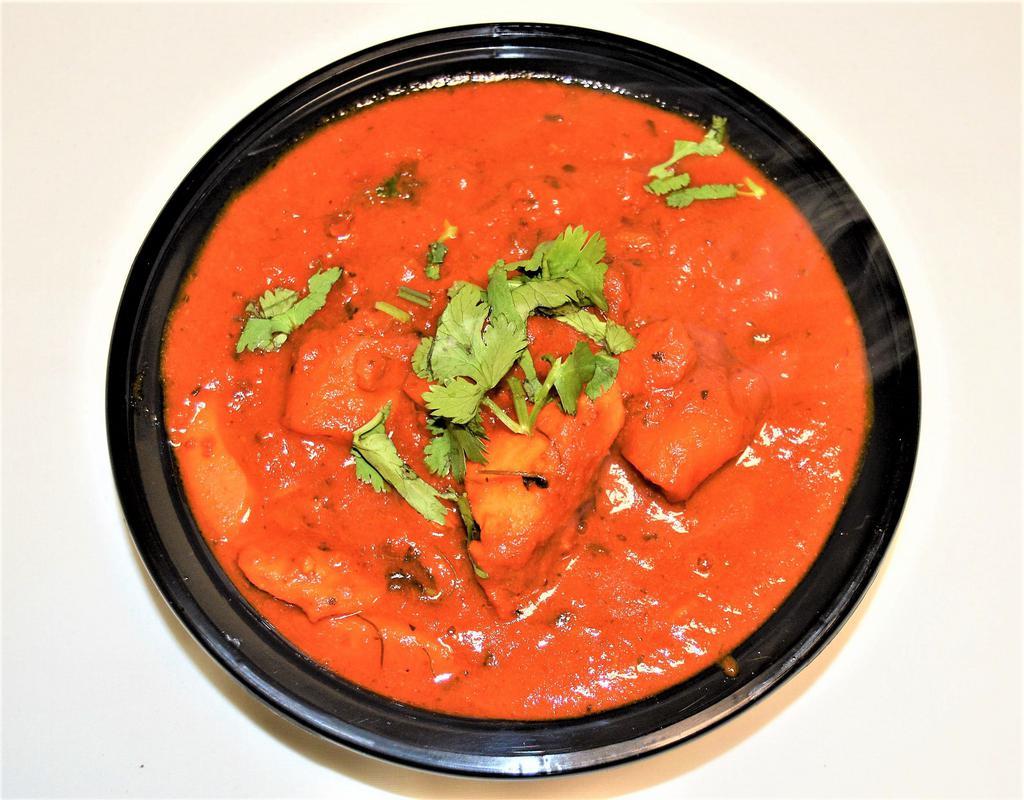 54. Chicken Vindalu · Tangy hot tomato sauce, spices, onion, ginger, garlic and vinegar. Spicy. Served with rice.