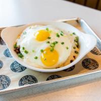 Stuffed Hash Browns · Filled with sausage, bacon, and cheddar cheese, topped with cream gravy, scallions and 2 eggs.
