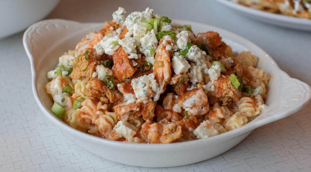 Buffalo Chicken Mac and Cheese · Curly pasta, cheddar cheese sauce, fried chicken, blue cheese crumbles and scallions, topped with buffalo sauce and buttermilk ranch.