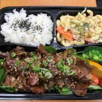 Yakiniku Bento · Stir fry sliced beef short ribs and onion with garlic soy sauce. Served with rice and pasta ...