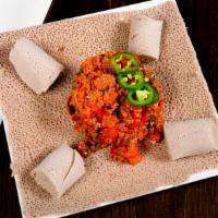 Timatim Fitfit · Diced vine ripened tomatoes, peppers, onions and crumbled injera, tossed in awaze and olive ...
