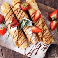 Crepe aux Fraises · Fresh strawberries, vanilla cream, whipped cream and powdered sugar.