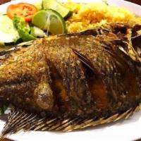 Mojarra Frita · Fried whole tilapia fish, side of Mexican rice, Ssalad and soft corn tortilla.