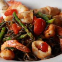 Squid Ink Tagliolini · Served with shrimp, calamari, asparagus and spicy tomato.