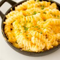 Skillet Mac · Rotini pasta tossed with housemade cheese sauce, topped with Parmesan cheese and baked to pe...