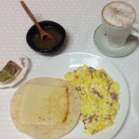 Huevos Revueltos con Jamon · Scrambled eggs with ham. Caffe latte, white toast or corn cake, sausage and hash brown. Plea...