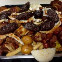 Picada Colombiana · Pork sausage, blood sausage, pork strips, pork ribs, fried green plantains, French fries, ye...