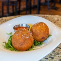 Arancini · Fried “risotto balls” filled with beef bolognese, green peas, mozzarella