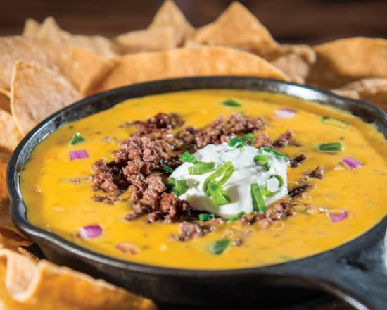 Jack’s Skillet Queso · House Made Queso topped with seasoned ground beef, sour cream and green onions. Served with chip and house made salsa