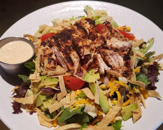 Santa Fe Blackened Chicken Salad · Topped with Jack and Cheddar Cheese, Cherry Tomatoes, Diced Red Onions, Sweet Corn, Chunks of fresh Avocado and Crispy Tortilla strips. Topped with Blackened Grilled Chicken and served with our House Made Santa Fe Ranch on the side.