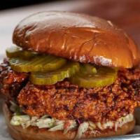 Nashville Hot · Hand Breaded Chicken tossed  in House Made Hot Sauce, Sweet Slaw, Onions and Pickles topped ...