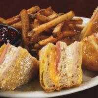 Monte Cristo Sandwich · A triple decker sandwich with turkey, ham, swiss and american cheese, battered and fried to ...