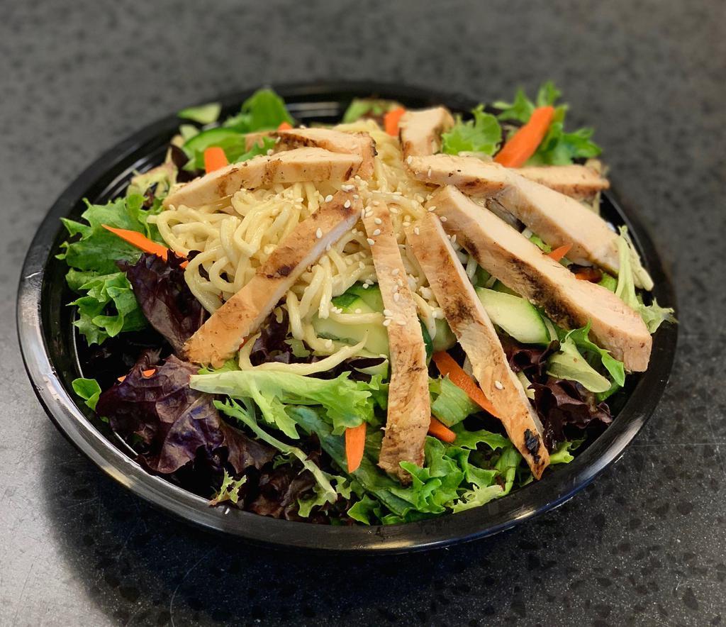 Asian Sesame Chicken Salad · Marinated all white chicken, sliced cucumbers, snap peas, fresh julienne carrots and Yaki Soba noodles on top of a fresh bed on lettuce. 