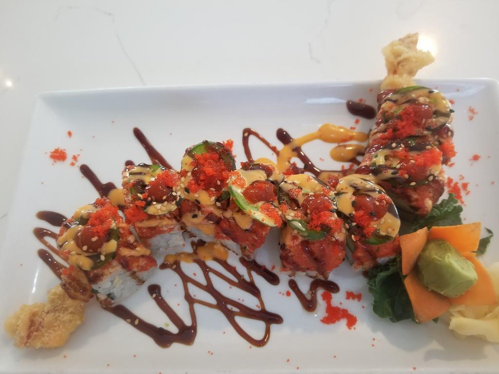 Fire Dragon Roll · Tempura shrimp, kani, cucumber topped with spicy tuna, jalapeno, eel sauce, spicy mayo, hot sauce and masago.